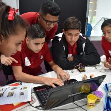 Jóvenes trabajando en equipo frente a computadora